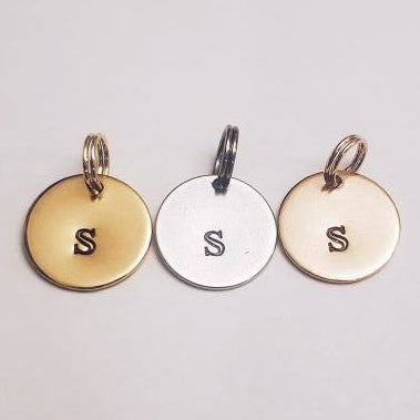 Three stainless steel charms, each stamped with the letter S. The charms are in gold, silver, and rose colour finish.